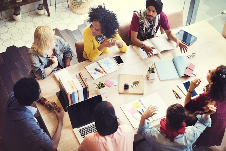 People meet around a table at work.
