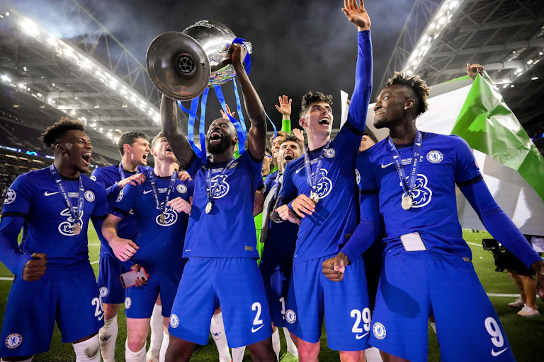 Chelsea players celebrate with the trophy.