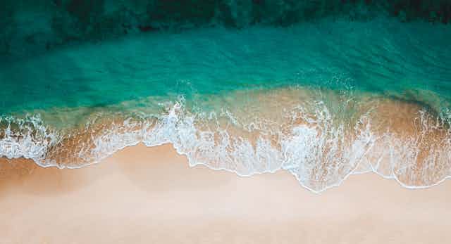 Ocean waves arriving at a sandy beach