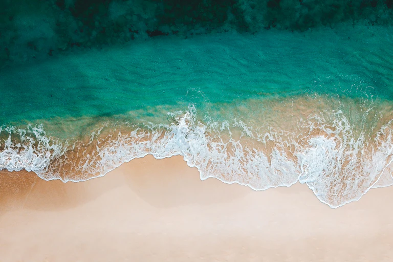 Ocean waves arriving at a sandy beach