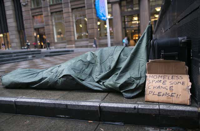 A person sleeps rough on the streets.