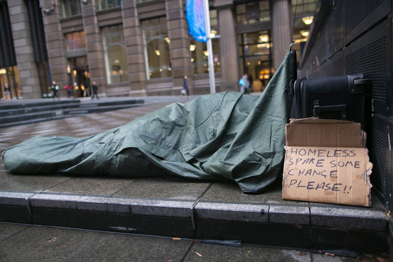 A person sleeps rough on the streets.