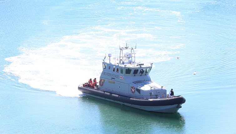 A UK Border Force travelling in the Channel carrying people rescued from the water.