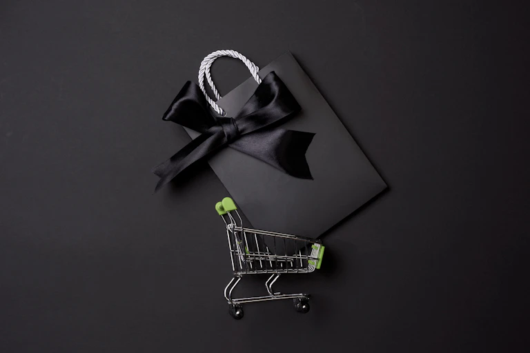 Trolley with a black gift bag in it