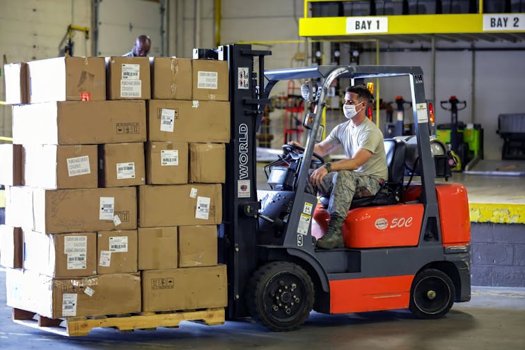 Forklift driver with a bundle of parcels