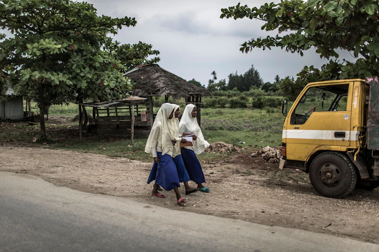 girls walking along a road