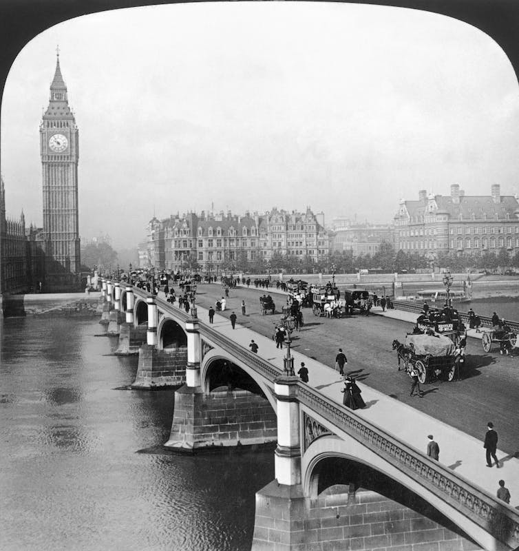 Pedestrians and carriages cross Westminster Bridge in 1901