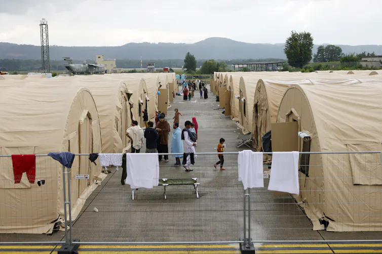 Two rows of US army tents housing Afghan refugees at the US airbase in Ramstein, Germany.