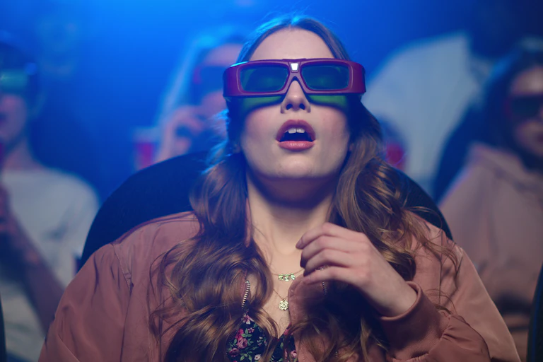 Image of a shocked woman feeling scared at cinema