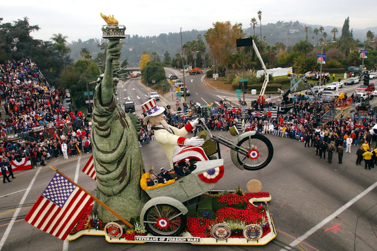 Uncle Sam riding a motorcycle next to Lady Liberty at a parade