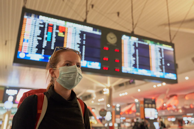 Woman in airport wearing mask