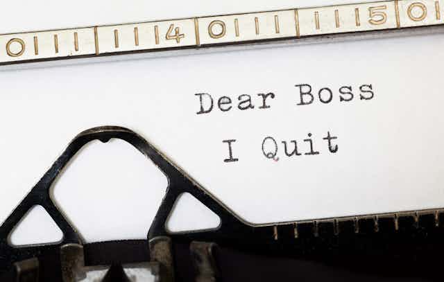 A close up of a piece of paper in a typewriter with the words dear boss I quit
