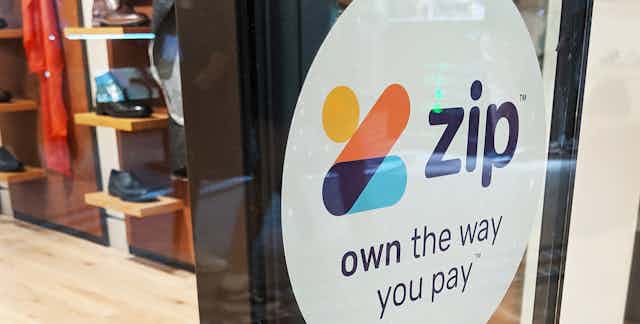 Zip Co sign on shop window.