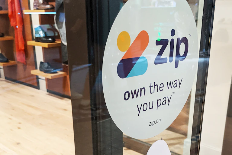 Zip Co sign on shop window.