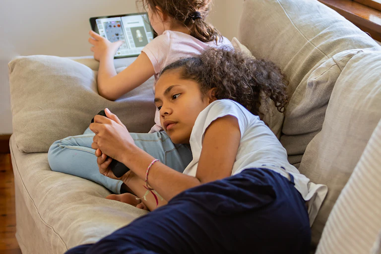 A person lying down looking at their phone.