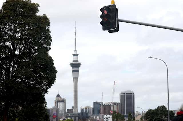 A red traffic light and the Auckland Sky Tower - signifying that New Zealand moves to a new COVID-19 protection framework, using a "traffic light" system to manage COVID-19.