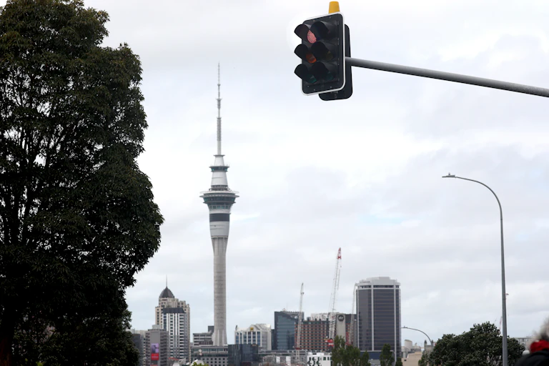 A red traffic light and the Auckland Sky Tower - signifying that New Zealand moves to a new COVID-19 protection framework, using a "traffic light" system to manage COVID-19.