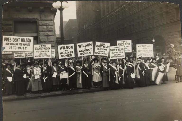 Women protest holding signs