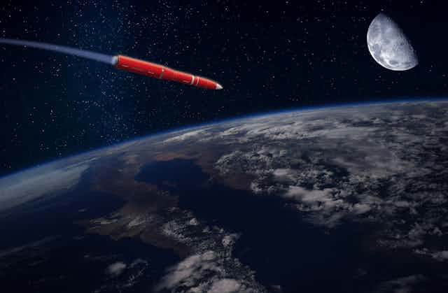 A missile flying through space towards the Earth's surface