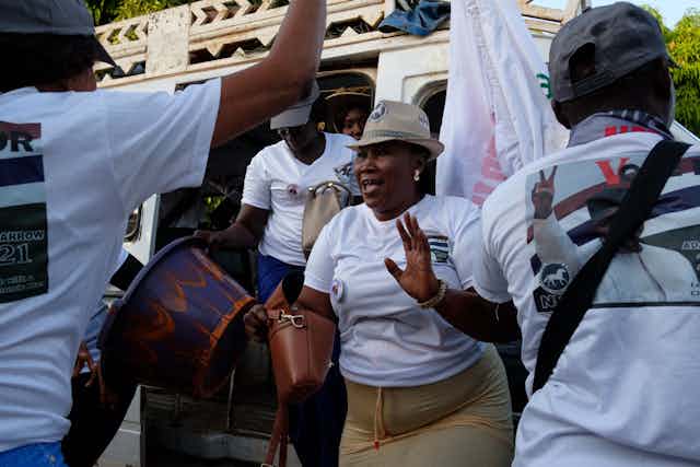 Women wearing white shirts and caps while dancing