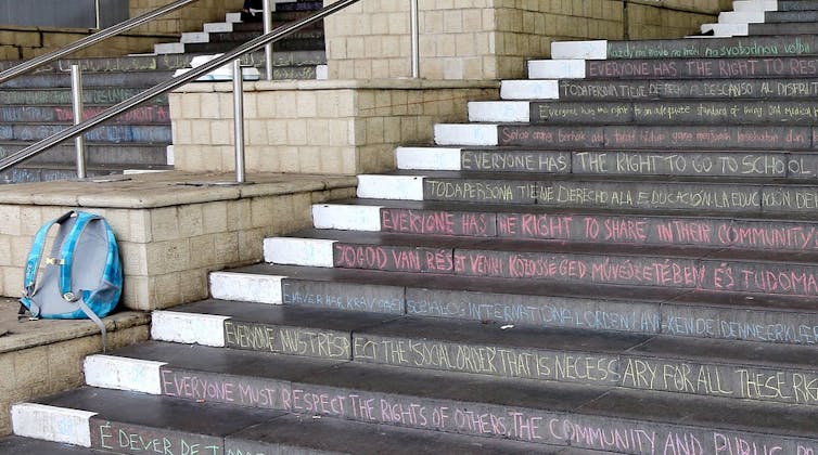 Chalk writing is seen on the edges of stairs.