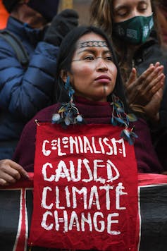An indigenous Amazonian woman during a protest against the Extinction Rebellion at COP26