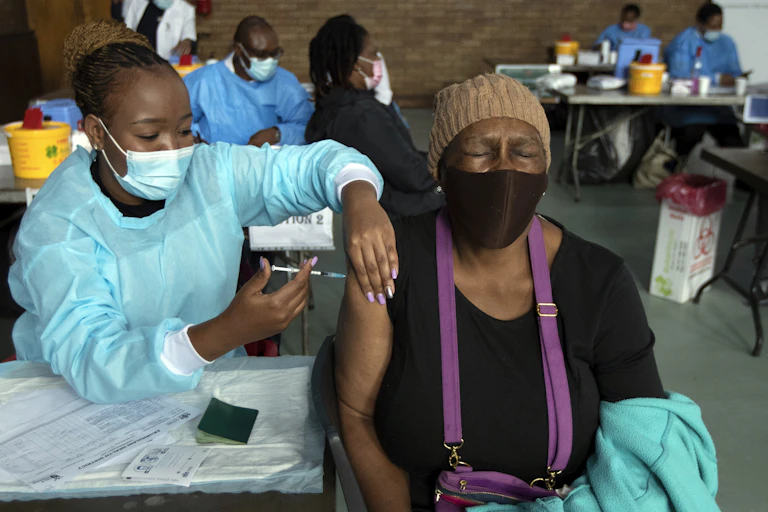 A woman receives Pfizer vaccine in South Africa.