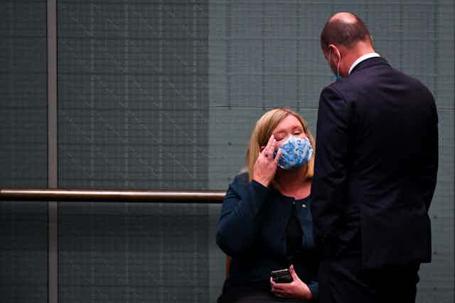 Josh Frydenberg speaking to Bridget Archer in parliament after she crossed the floor.