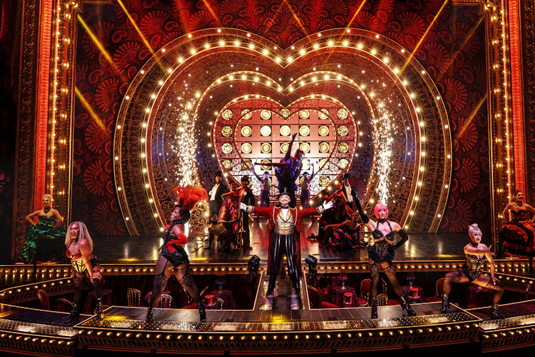 Production image: a red glitzy stage
