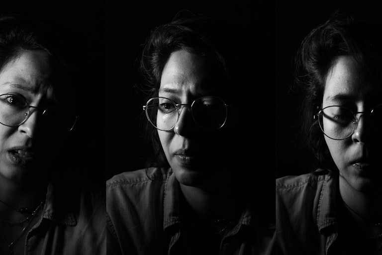 A triptych of images shows a woman photographed in black and white, her facial expressions different in each image. She is wearing glasses and looks both serious and sad.