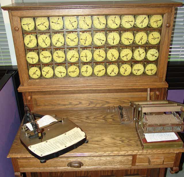an antique wooden machine including a bank of 40 display dials
