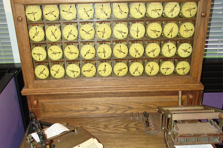 an antique wooden machine including a bank of 40 display dials