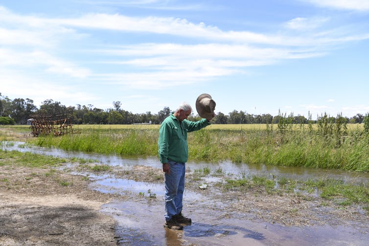 Farmer standing in flood waters