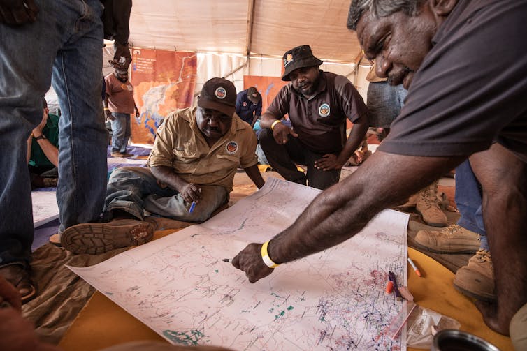 Men sitting around a map