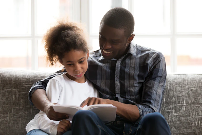 A parent reads a book to their child.