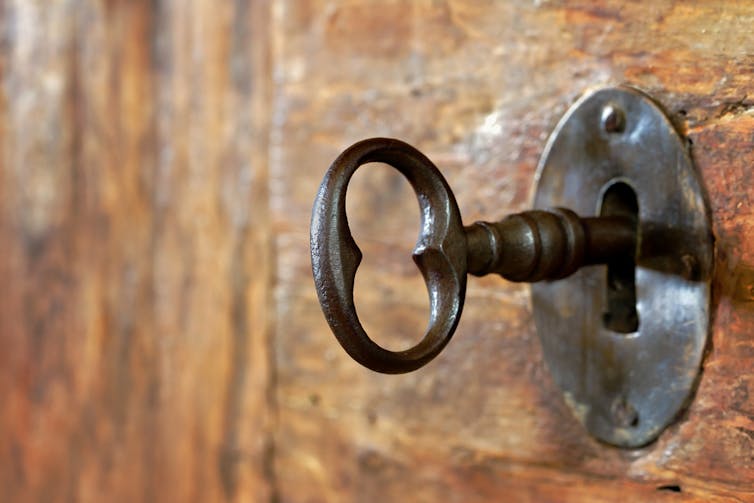 Key in lock of old, antique wooden door