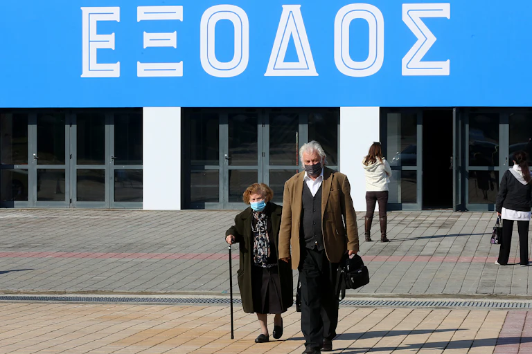An elderly couple leave a vaccination centre in Greece.