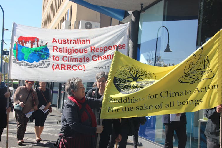 People hold banners on the street