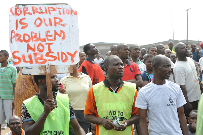 A group of people standing with a placard