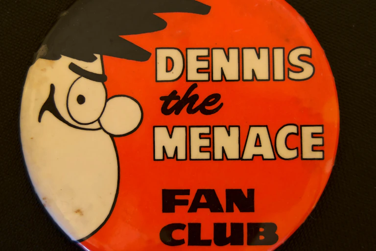 A Dennis the Menace badge.