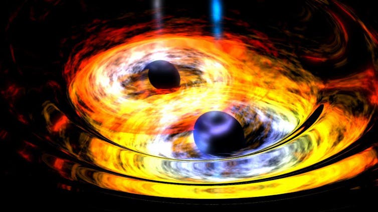 Two black holes surrounded by yellow and orange flames spiralling into each other.