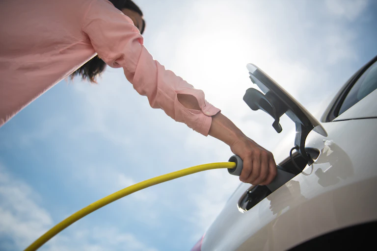 Woman charging electric car
