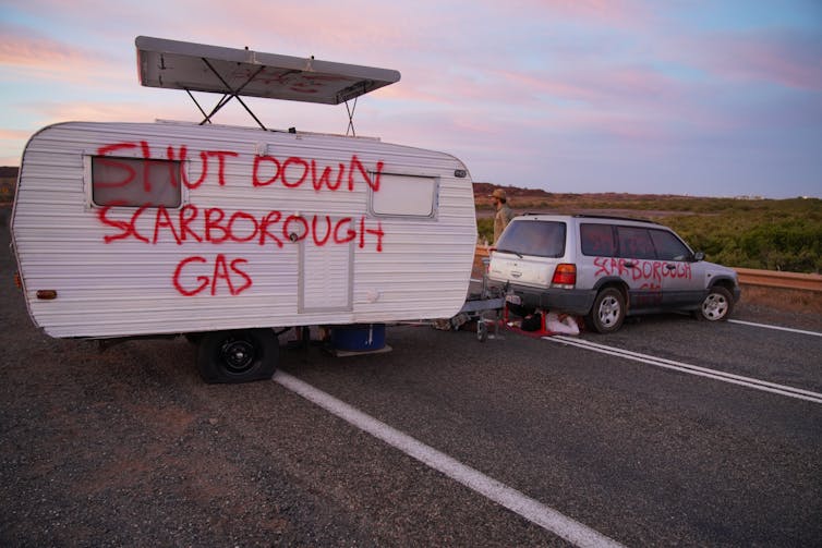 Car and caravan with words 'Shut down Scarborough gas' block road