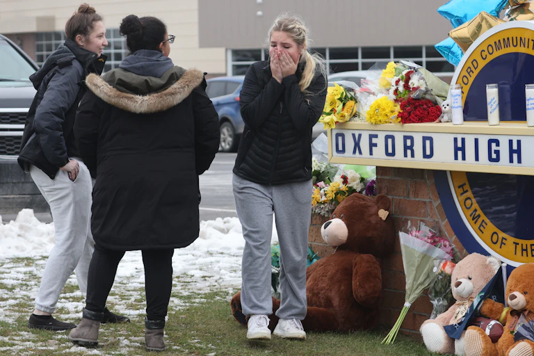 A group of teenage girls visits a memorial
