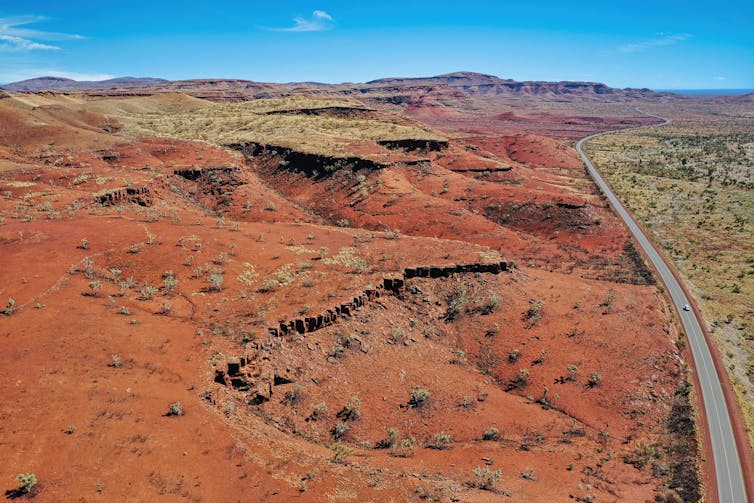 Image of the Pilbara region in Western Australia known for the red earth and its vast mineral deposits in iron ore – oxygen and iron atoms bonded together into molecules.
