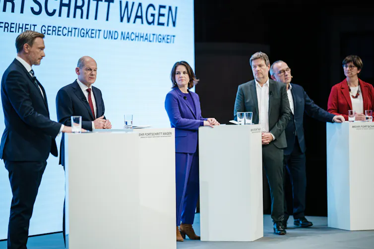 Olaf Scholz's SPD unveiling the new ruling coalition with the Greens and FDP.