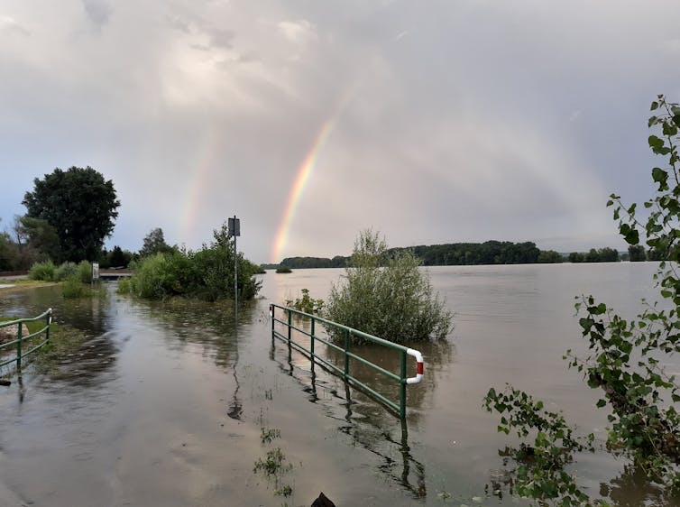 A rainbow above flooded land