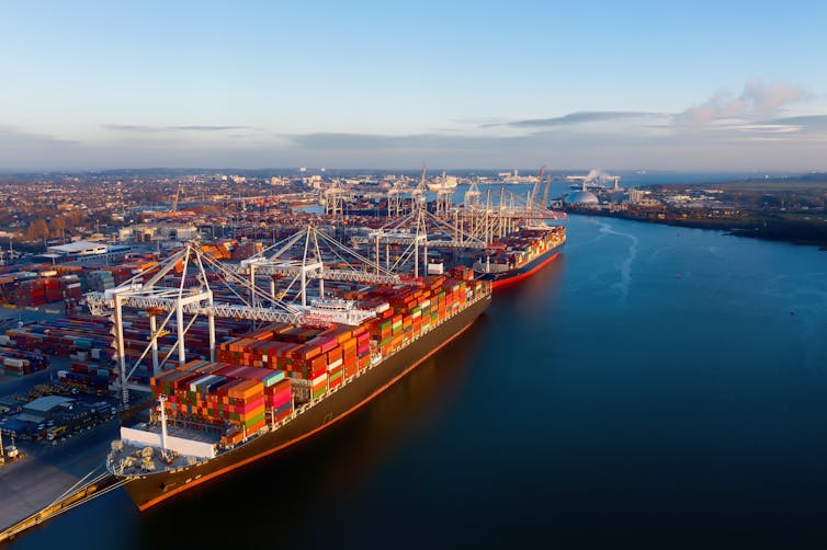 Two container ships laden with cargo docked in Southampton port.