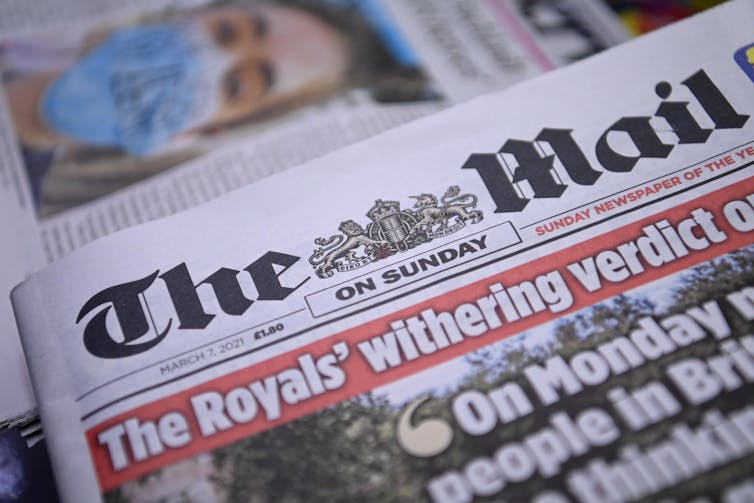 A photograph of a copy of The Mail on Sunday with a headline about the royal family.