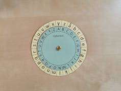 A paper wheel with different symbols sits on a desk.